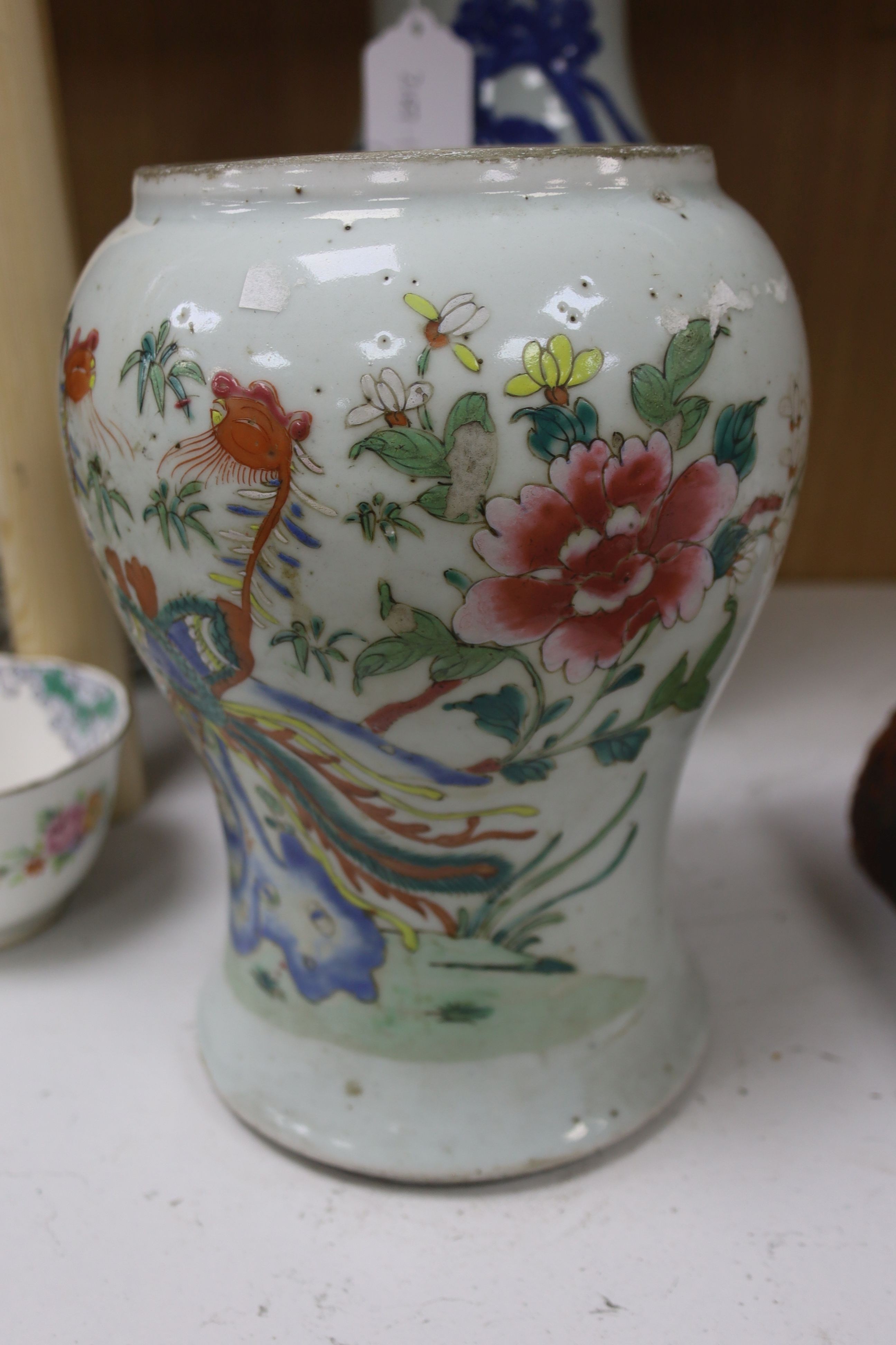 A Chinese blue and white 'Immortals' vase, 18th/19th century, damage, 34.5cm and a Chinese Yongzheng period famille rose ‘phoenix’ vase (reduced in height), 24cm